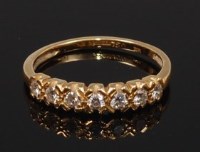 Lot 2300 - An 18ct gold diamond seven stone ring, the...