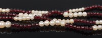 Lot 2305 - A beaded cultured pearl and garnet single...