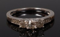 Lot 2101 - An 18ct white gold diamond three stone ring,...