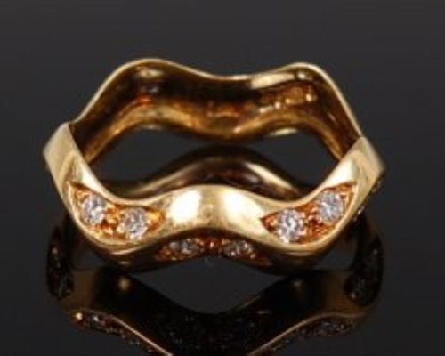 Lot 2132 - A modern 18ct gold diamond set half eternity...