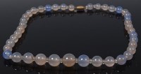 Lot 2149 - A beaded and graduated AGATE necklace, having...