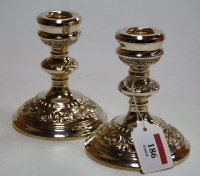 Lot 186 - A pair of silver dwarf table candlesticks,...