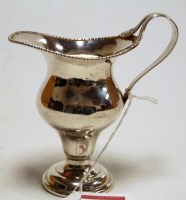 Lot 214 - A George V silver helmet shaped cream jug of...