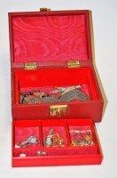 Lot 284 - A red vinyl clad jewellery box and contents,...