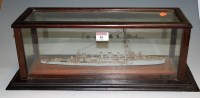 Lot 48 - A cased model of a painted metal military ship