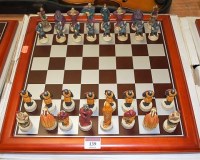 Lot 139 - A contemporary figural chess set with board,...