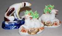 Lot 185 - A pair of ceramic recumbent sheep in the...