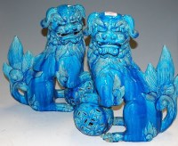 Lot 105 - A pair of Chinese glazed stoneware seated dogs...
