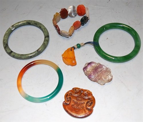 Lot 450 - Three Chinese jadeite bangles; together with...