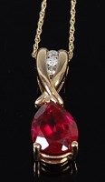 Lot 2232 - A 9ct gold, ruby and diamond pendant, the...