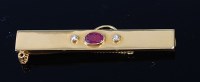 Lot 2105 - An 18ct gold, ruby and diamond set money clip...