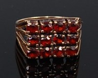 Lot 2248 - A 9ct gold and garnet set tablet ring,...