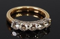 Lot 2304 - An 18ct yellow gold and diamond five stone...