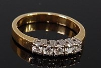 Lot 2305 - An 18ct gold diamond five stone ring, the claw...