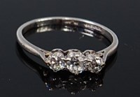 Lot 2320 - A platinum and diamond three stone ring, the...