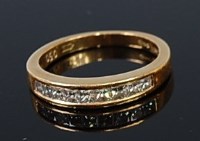 Lot 2316 - An 18ct gold and diamond half eternity ring,...