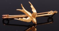 Lot 2002 - A 15ct gold safety pin brooch surmounted with...