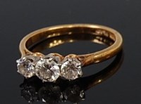 Lot 2004 - An 18ct gold diamond three stone ring, the...