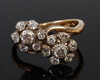 Lot 2006 - An 18ct gold diamond crossover ring arranged...