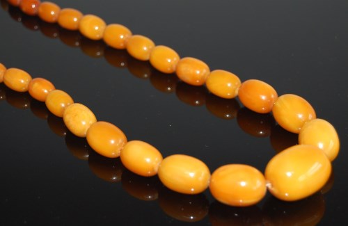 Lot 2009 - A beaded faux butterscotch amber single string...