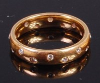 Lot 2012 - A contemporary 18ct gold diamond set band ring...