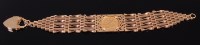 Lot 2028 - A 9ct gold gate link bracelet containing a...