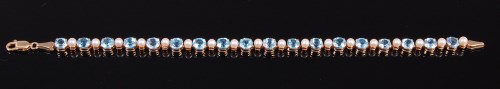 Lot 2043 - A modern 9ct gold, blue topaz and seed pearl...
