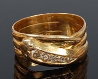 Lot 2055 - An 18ct gold diamond set snake ring, its head...