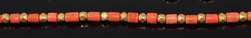 Lot 2063 - A beaded red coral and high carat yellow metal...