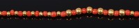 Lot 2064 - A beaded red coral and high carat yellow metal...