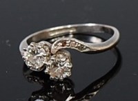 Lot 2077 - A platinum diamond crossover ring, the claw...