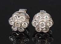 Lot 2088 - A pair of platinum and diamond flower head...