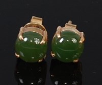 Lot 2089 - A pair of yellow metal and cabochon green jade...