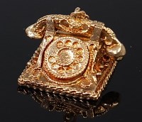 Lot 2093 - A 9ct gold charm modelled as a vintage...
