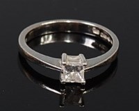 Lot 2099 - A platinum diamond solitaire ring, the four...
