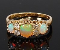 Lot 2111 - An 18ct gold, opal and diamond ring arranged...