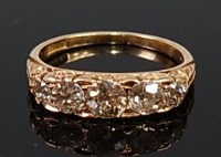 Lot 2124 - An 18ct gold and diamond five stone ring, the...