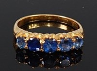 Lot 2125 - An 18ct gold sapphire five stone ring, the...