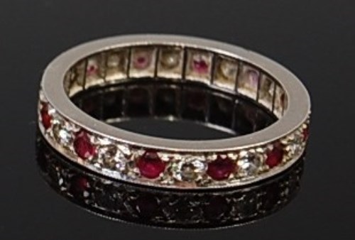 Lot 2139 - A platinum, ruby and diamond set eternity ring,...