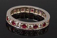 Lot 2139 - A platinum, ruby and diamond set eternity ring,...