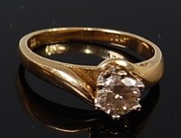 Lot 2148 - An 18ct gold diamond solitaire ring, the claw...