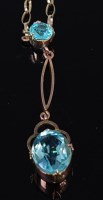 Lot 2166 - A 9ct gold and blue topaz set pendant, on...