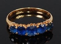 Lot 2188 - An 18ct gold sapphire five stone ring, the...