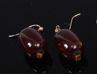 Lot 2191 - A pair of ruby glass ear pendants, on yellow...