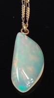 Lot 2204 - A polished opal pendant, weighing approx 15ct,...