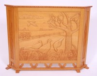 Lot 597 - A light oak fire screen, the front panel...