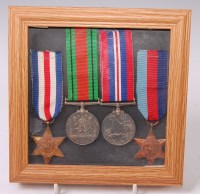 Lot 346 - A group of four WW II medals to include...