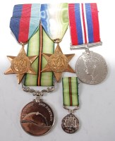 Lot 521 - A group of four medals to include WW II...