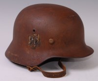 Lot 332 - A German M35 steel helmet with remains of SS...