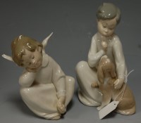 Lot 201 - A Lladro figure modelled as a seated child...